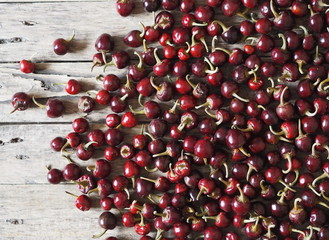 Red round hot cherry pepper dried on a wooden background. We grow and dry ourselves. Organic products.