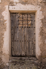old wooden door, old wood door in Spanish village, old dirty door made of wood material