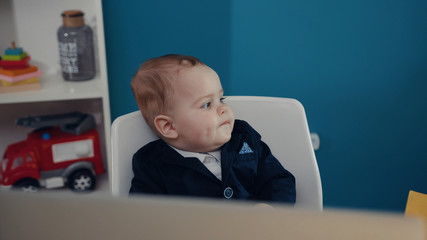Portrait little boy businessman boss boy in office use laptop phone look at camera sitting play creative little happy job kid work child computer education young suit cute career confident slow motion