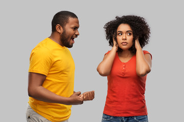 relationships and people concept - unhappy african american couple having argument over grey background