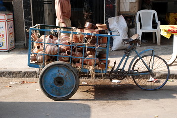 cargo tricycle full of clay pots