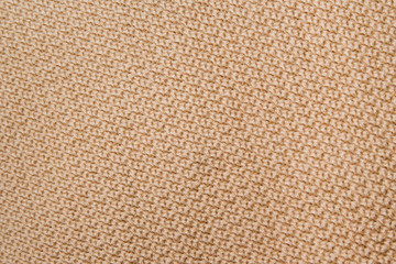 Knitted fabric wool texture close up as a background.