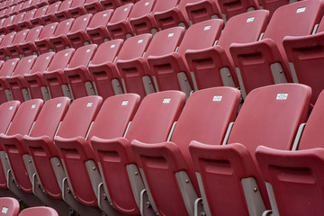 Naklejka premium Rows of red empty seats in stadium