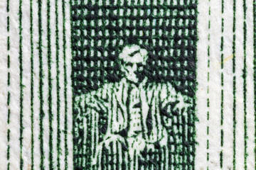 Macro close up photograph of the Abraham Lincoln Memorial on the US Five Dollar Bill.