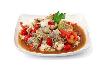 Thai Style spicy seafood salad with shrimps isolated on the white background with clipping path.