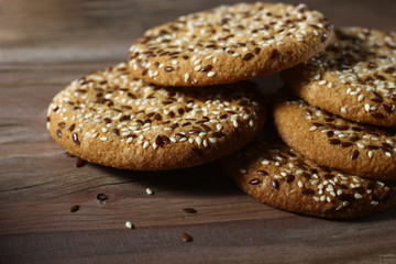 sweet cookies with sesame seeds on a wooden table