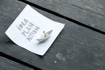 idea plan action concept, inscription and paper boat