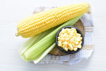 fresh organic corn in leaf, shelled and in pieces