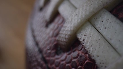 Close up macro of an American Football showing the texture of the leather and laces