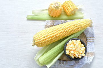 fresh organic corn in leaf, shelled and in pieces