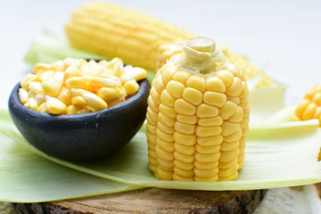 fresh organic corn in leaf, shelled and in pieces