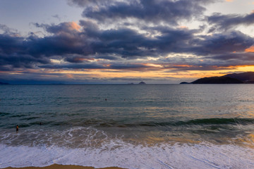 Obraz premium Nha Trang, Vietnam sunrise featuring south China Sea, East Sea, distant islands and a ship wreck in the foreground beach
