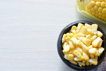 fresh organic corn in leaf, shelled and in pieces