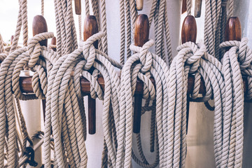 Ship ropes tied to the mast before lowering sails.