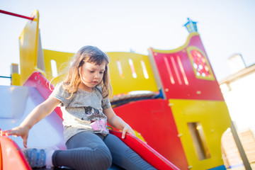 Little kid on playground, children's slide
