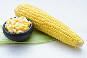 fresh organic corn in leaf, shelled and in pieces