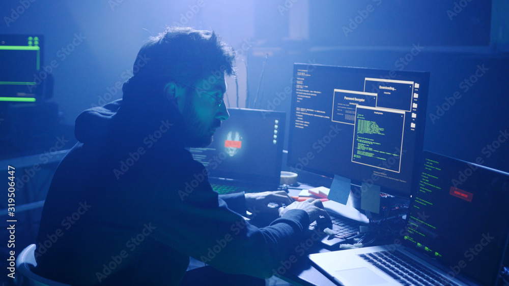 Poster profile of confident programmer coding technology typing on laptop in the smoky room at night.
