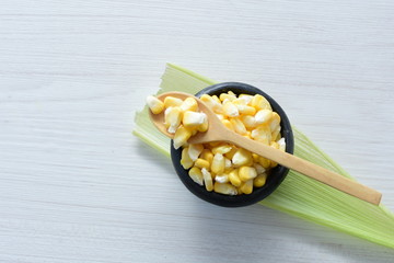 fresh organic corn in leaf, shelled and in pieces