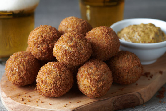 Bitterballen are a Dutch meat-based snack, made by making a very thick stew thickened with roux and beef stock and generously loaded with meat.