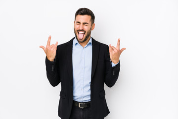 Young caucasian business man against a white background isolated showing rock gesture with fingers
