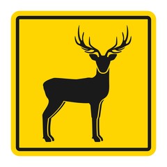 Wild animals yellow road sign. Silhouette of standing deer