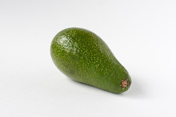 Green fresh avocado on a white background.