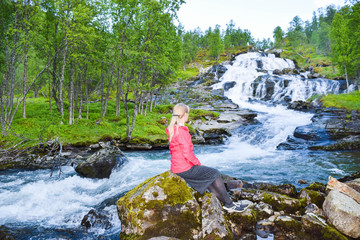 Tourist woman near waterfall.  Aurlandsfjellet. Norway.