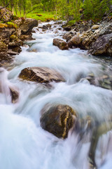 Blurry motions water of river. .River along the Aurlandsfjellet mountains in Norway.