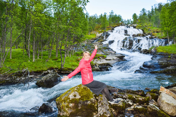 Tourist woman near waterfall.  Aurlandsfjellet. Norway.
