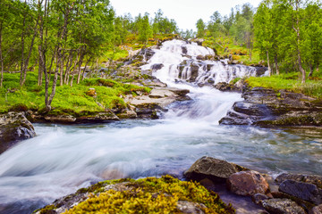 Naklejka na ściany i meble Blurry motions water of waterfall is located in Aurlandsfjellet mountains. Norway. Making long time exposure.
