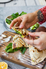 Spinach stuffed bread. Qutab flat bread filled with greens. Vegan healthy food. Woman hands holds.