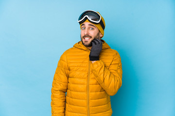 Young skier caucasian man isolated biting fingernails, nervous and very anxious.