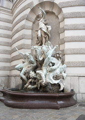Vienna, Austria - June 4, 2019; Marble fountain called Brunnen Macht zur See on the Michaelerplatz a square in front of the Hofburg palace the center of Vienna