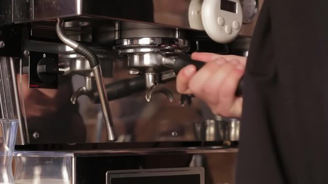 Coffee machine filling a cup with hot fresh coffee. Preparation of coffee, close up.