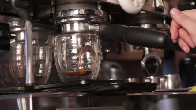 Coffee machine filling a cup with hot fresh coffee. Preparation of coffee, close up.