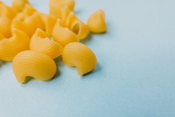 Wheat Italian pasta isolated on a blue background. top view 