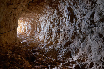 Cave rock tunnel through rock formation in Natural Park of Peñón de Ifach. Calpe, Costa Blanca,...