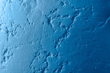 Abstract texture of a blue wall with cracks. Decorative putty for concrete with place for text.