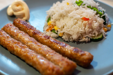 baked sausages and rice with vegetables