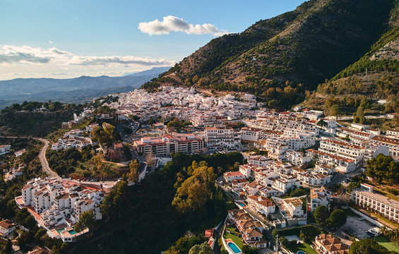 Aerial photo distant view charming Mijas pueblo, typical Andalusian white-washed mountain village, houses rooftops, small town located on hillside Province of M&aacute;laga, Costa del Sol, Europe, Spain