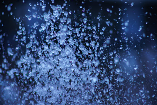 Water drops macro photography. Background is dark and blurry.