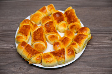 Fresh homemade croissants on wooden table, selective focus