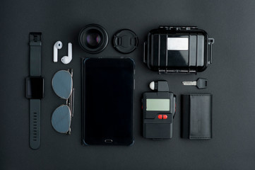 Top view of workspace photographer with digital photometer, lens and cover, black waterproof case,...