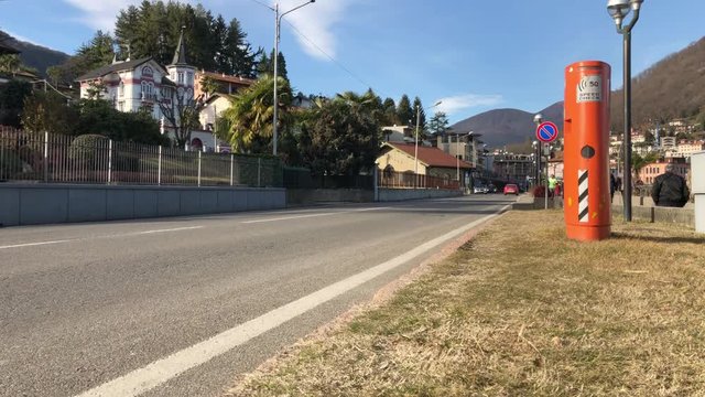The road with traffic controlled with the speed control device in Lavena Ponte Tresa, 4K, time-lapse