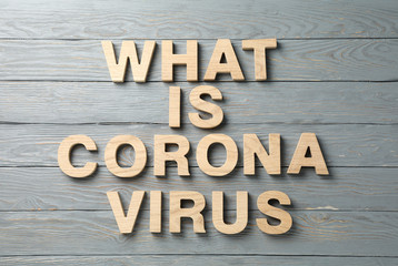 Inscription What is Coronavirus on wooden gray background, top view. Healthcare and medical concept