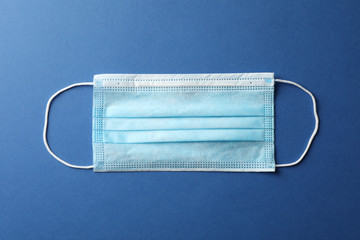 Protective mask on blue background, top view, space for text.Virus protection. Healthcare and...