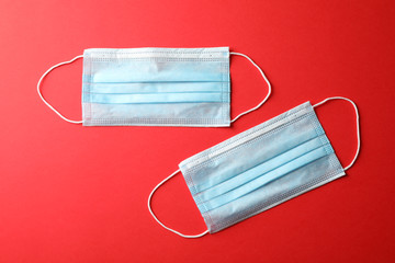 Protective mask on red background, top view, space for text.Virus protection. Healthcare and...