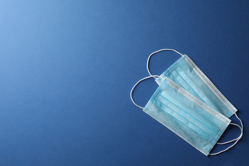 Protective mask on blue background, top view, space for text.Virus protection. Healthcare and...