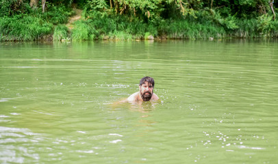 Best way to relax. brutal hipster with wet beard. refreshing in river water. water beast. furry monster. wild man. time to relax. bearded man swimming in lake. summer vacation. mature swimmer