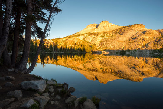 Mount Hoffmann reflects in May Lake at sunrise in Yosemite National Park, California.